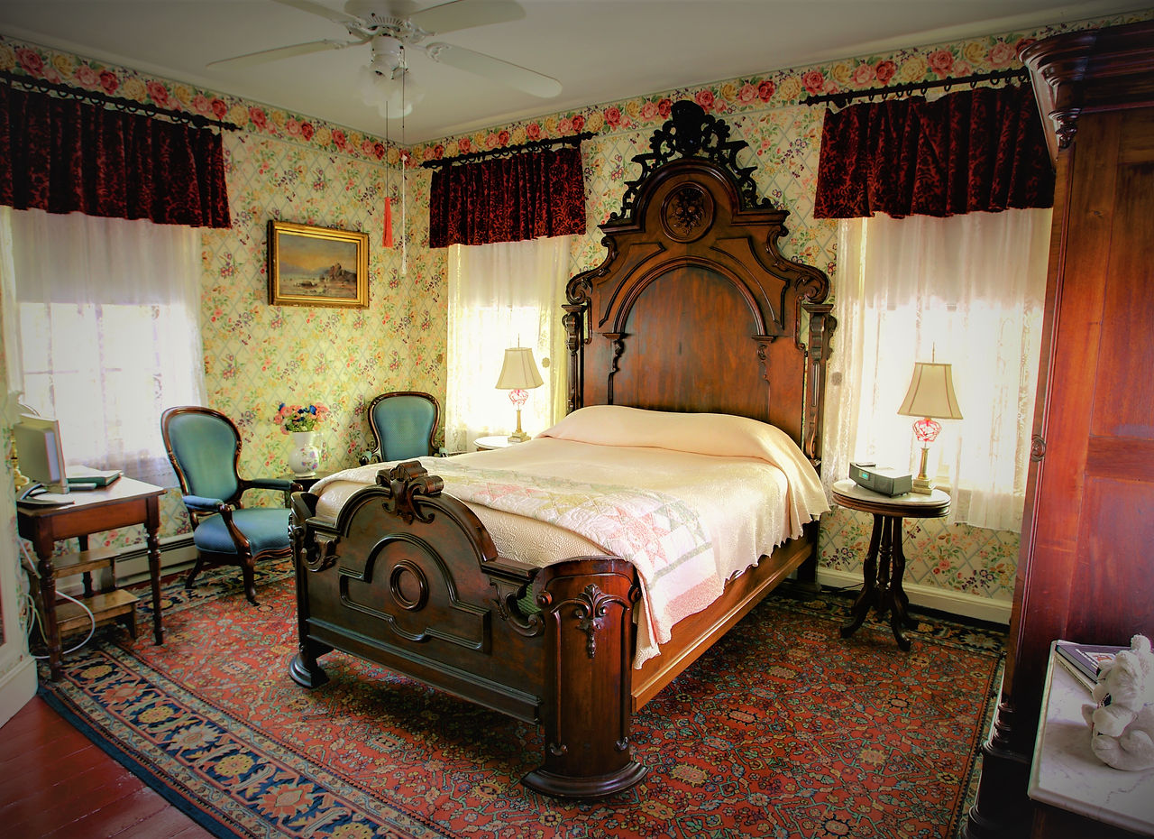 The Bret Harte Room with carved headboard